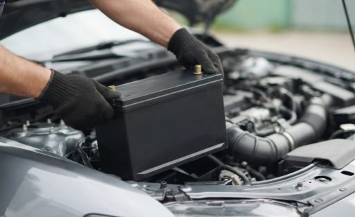 Car battery being fitted into an engine bay (AI-generated illustration)